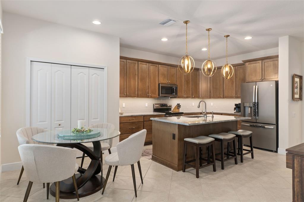 14617 Balloch Drive Hudson, FL 34667 - Photo 14 of 76 a kitchen with kitchen island a dining table chairs sink and cabinets