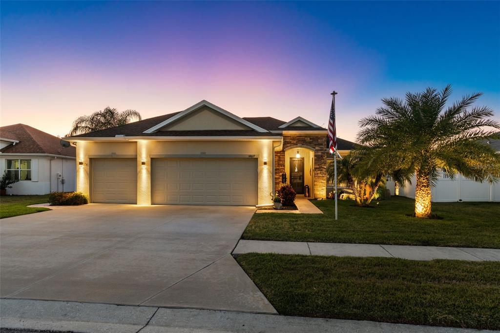 14617 Balloch Drive Hudson, FL 34667 - Photo 2 of 76 a front view of a house with a yard and garage