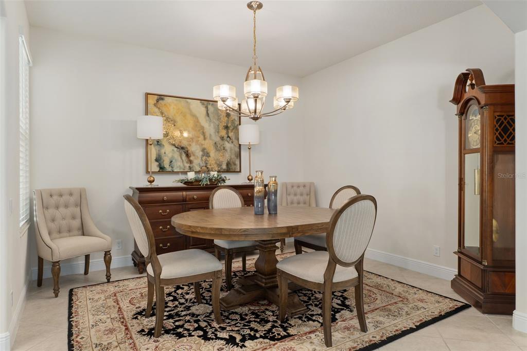 14617 Balloch Drive Hudson, FL 34667 - Photo 21 of 76 a dining room with furniture a rug and a chandelier