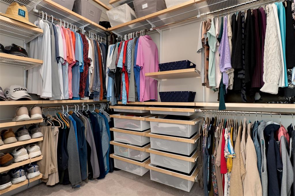 14617 Balloch Drive Hudson, FL 34667 - Photo 31 of 76 a view of walk in closet with clothes and shoes