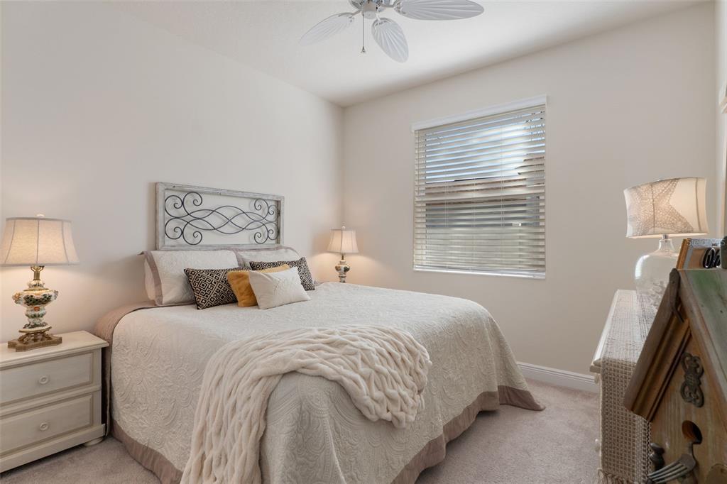 14617 Balloch Drive Hudson, FL 34667 - Photo 33 of 76 a bedroom with a bed and a chandelier