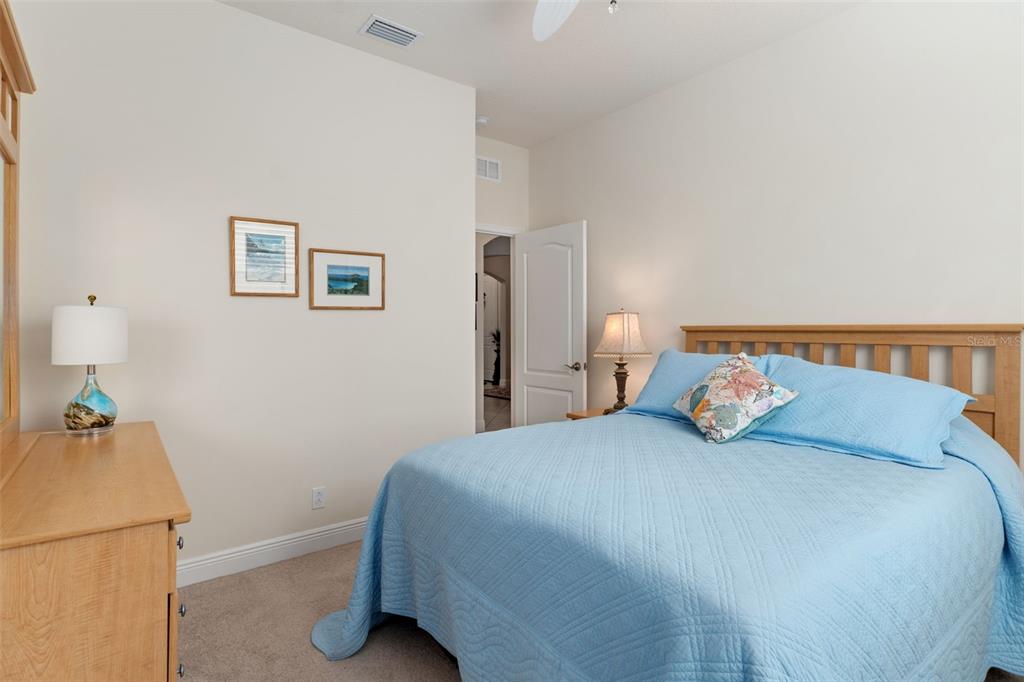 14617 Balloch Drive Hudson, FL 34667 - Photo 36 of 76 a bedroom with a bed and a lamp