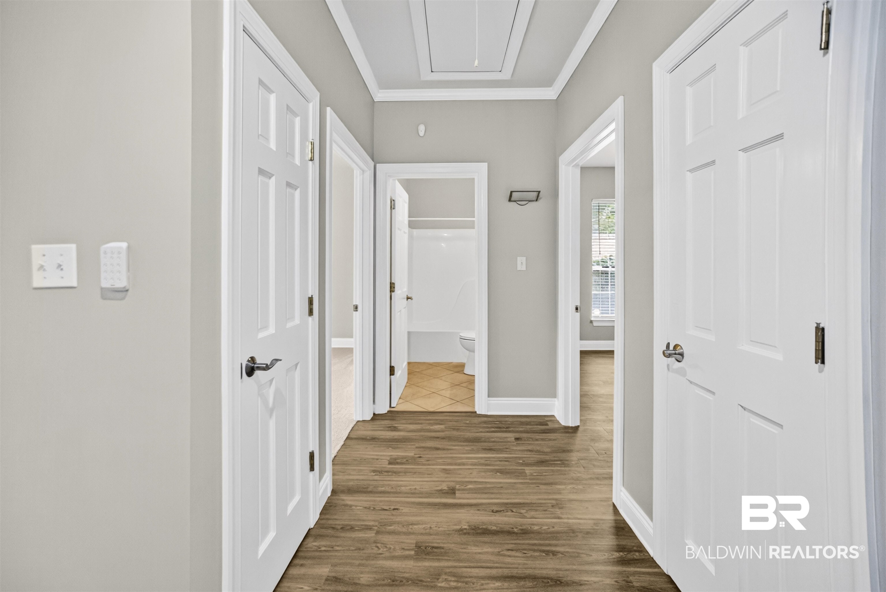 5913 Antoine Road Mobile, AL 36693 - Photo 24 of 33 Hallway featuring wood-finish flooring, light gray wall paint, and white trim molding