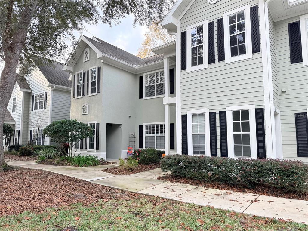 a front view of a house with yard and green space