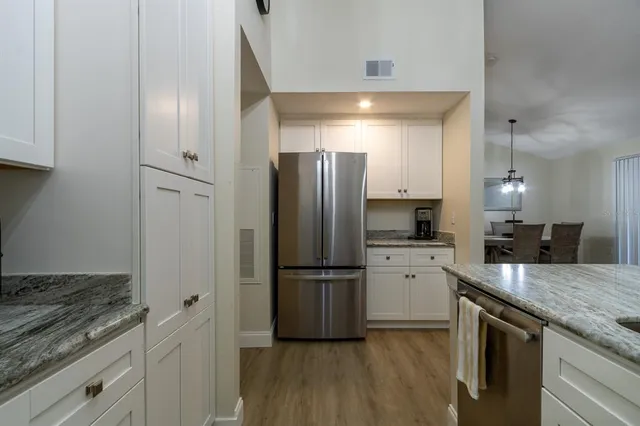 a kitchen with a refrigerator and a sink
