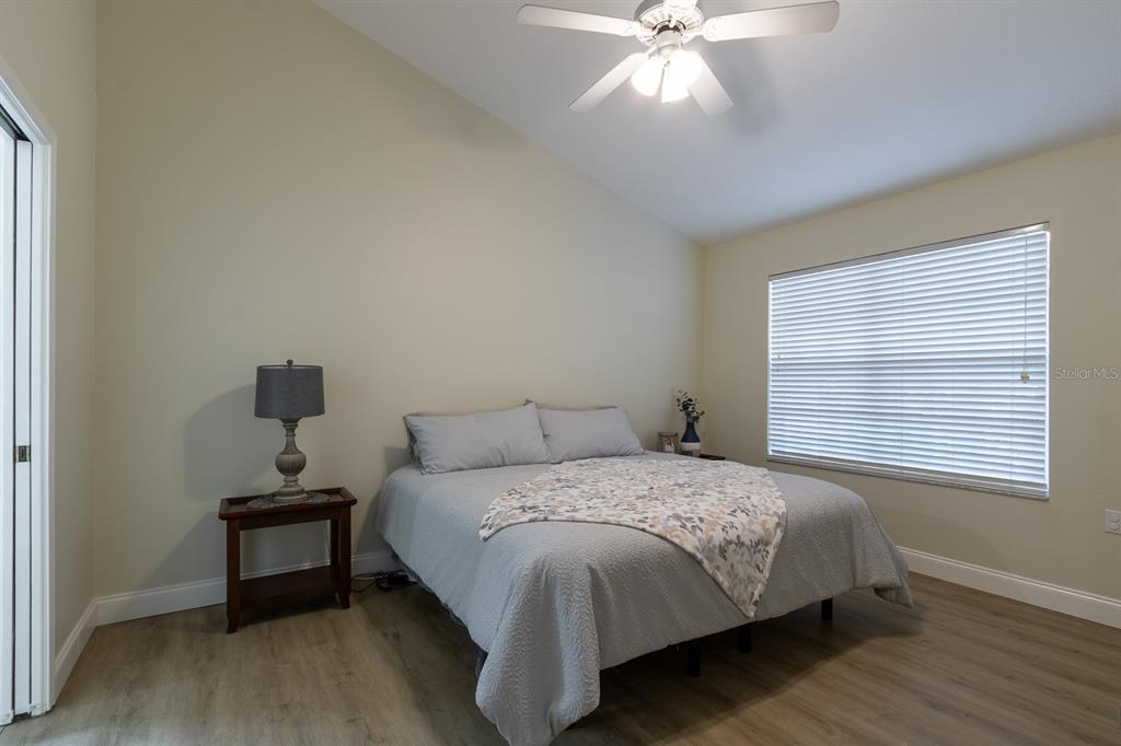 10000 Southwest 52nd Avenue, Unit 60 Gainesville, FL 32608 - Photo 12 of 36 a bedroom with a bed and a chandelier
