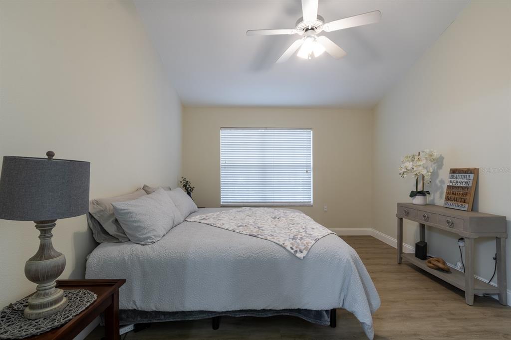 10000 Southwest 52nd Avenue, Unit 60 Gainesville, FL 32608 - Photo 13 of 36 a bedroom with a bed and a chandelier