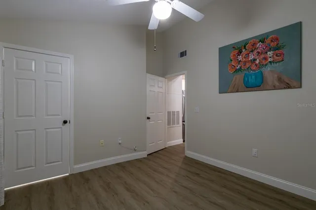 a view of an empty room with wooden floor