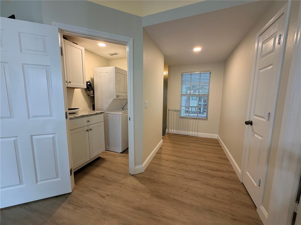 10000 Southwest 52nd Avenue, Unit 60 Gainesville, FL 32608 - Photo 23 of 36 a view of a hallway and a sink and a wooden floor in a room