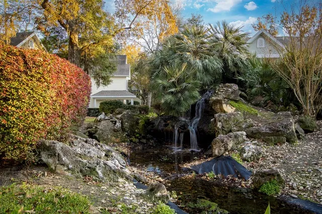 a view of a house with a yard and tree s