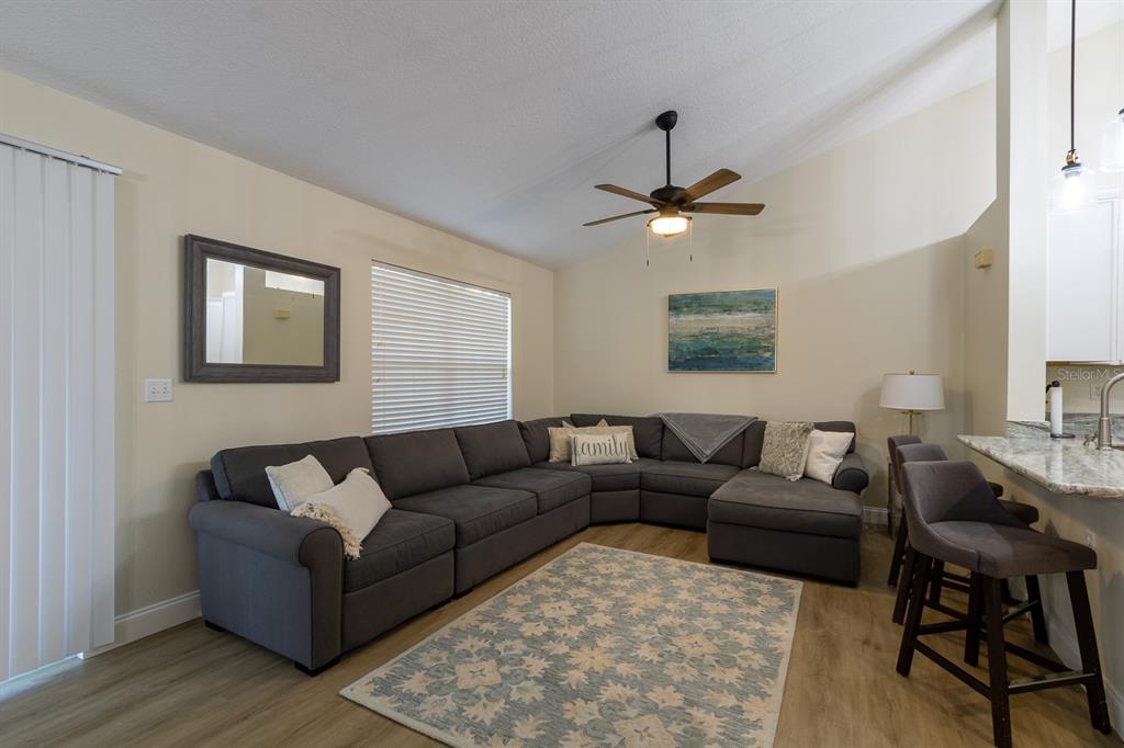10000 Southwest 52nd Avenue, Unit 60 Gainesville, FL 32608 - Photo 5 of 36 a living room with furniture a ceiling fan and a window