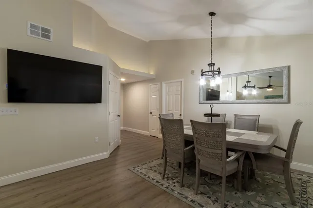 a view of a dining room with furniture wooden floor and chandelier