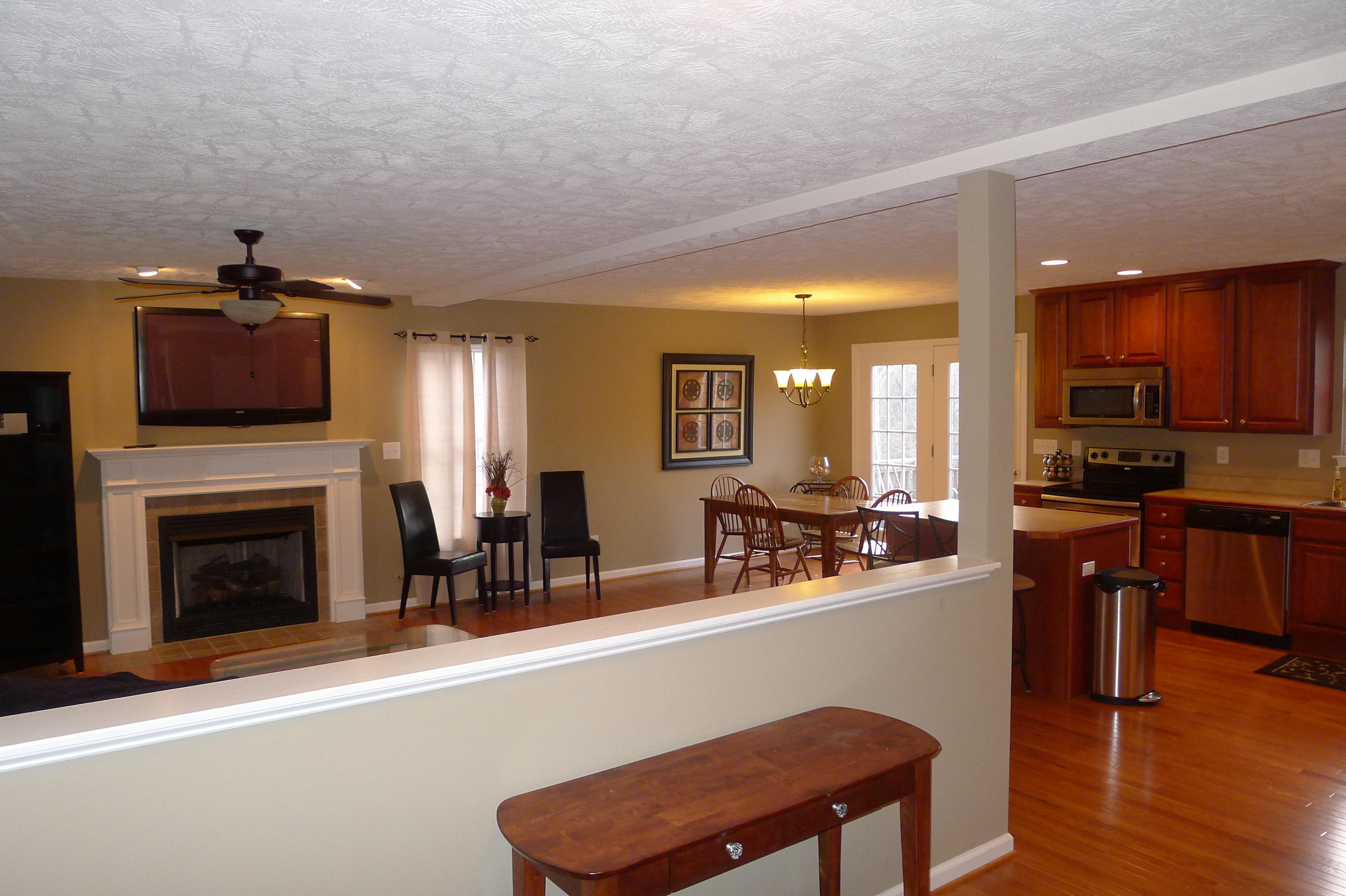 2850 Green Ridge Road Northwest Roanoke, VA 24019 - Photo 6 of 30 a living room with furniture a fireplace and kitchen view