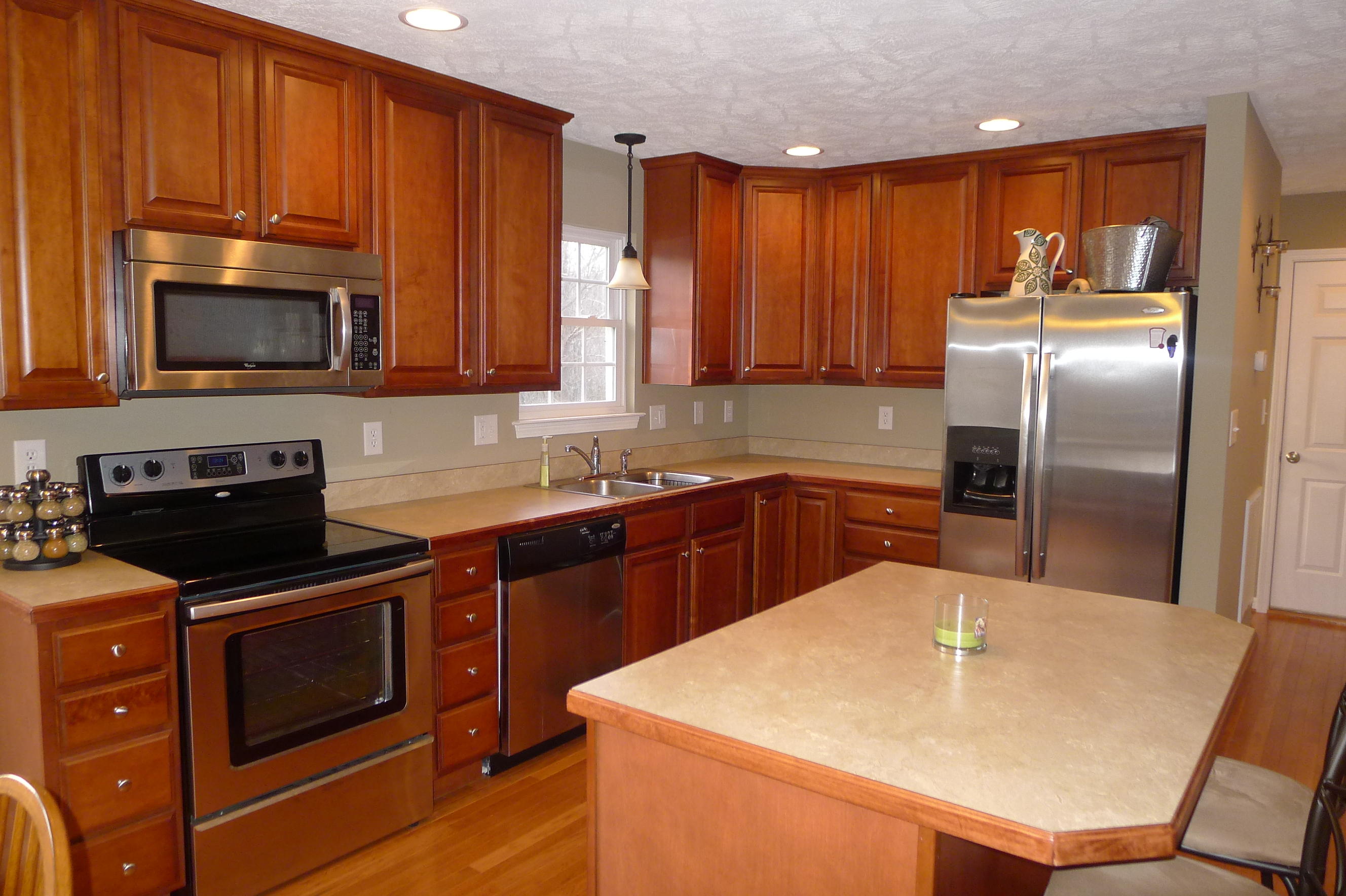 2850 Green Ridge Road Northwest Roanoke, VA 24019 - Photo 9 of 30 a kitchen with stainless steel appliances wooden cabinets a stove a sink and a microwave