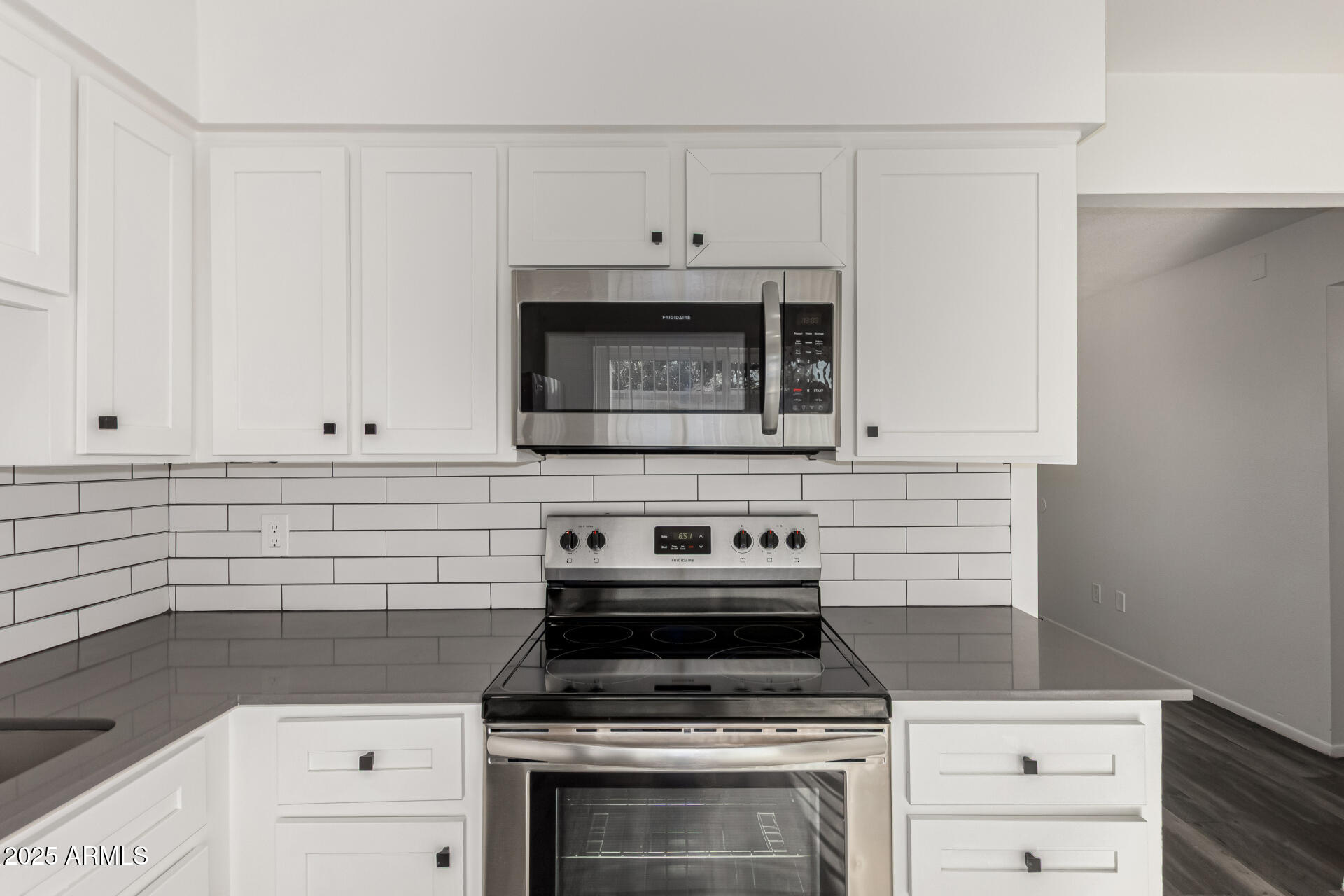 131 North Horne, Unit E Mesa, AZ 85203 - Photo 11 of 26 a kitchen with granite countertop white cabinets and white stove