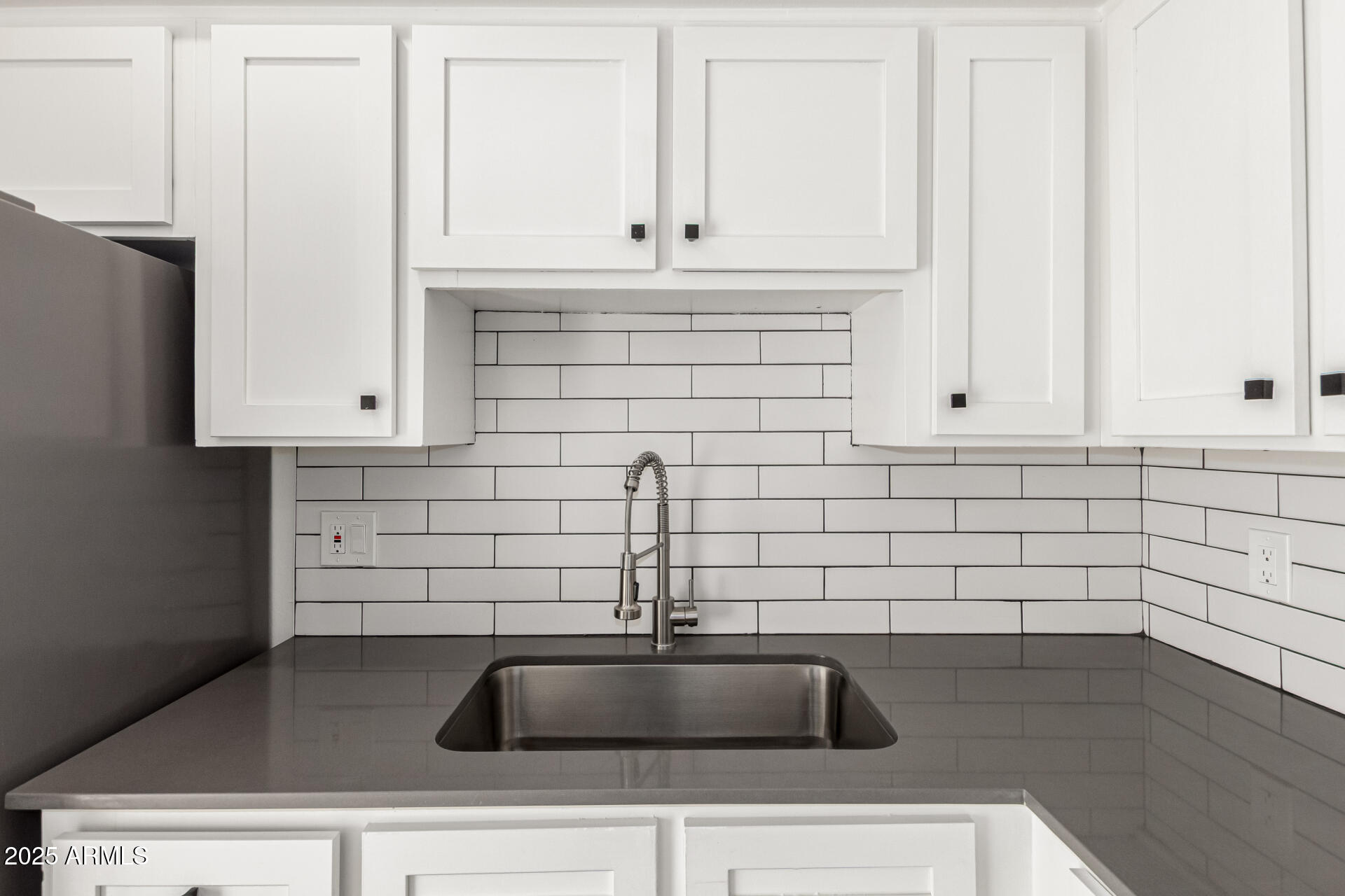 131 North Horne, Unit E Mesa, AZ 85203 - Photo 12 of 26 a kitchen with granite countertop a sink and a granite counter tops