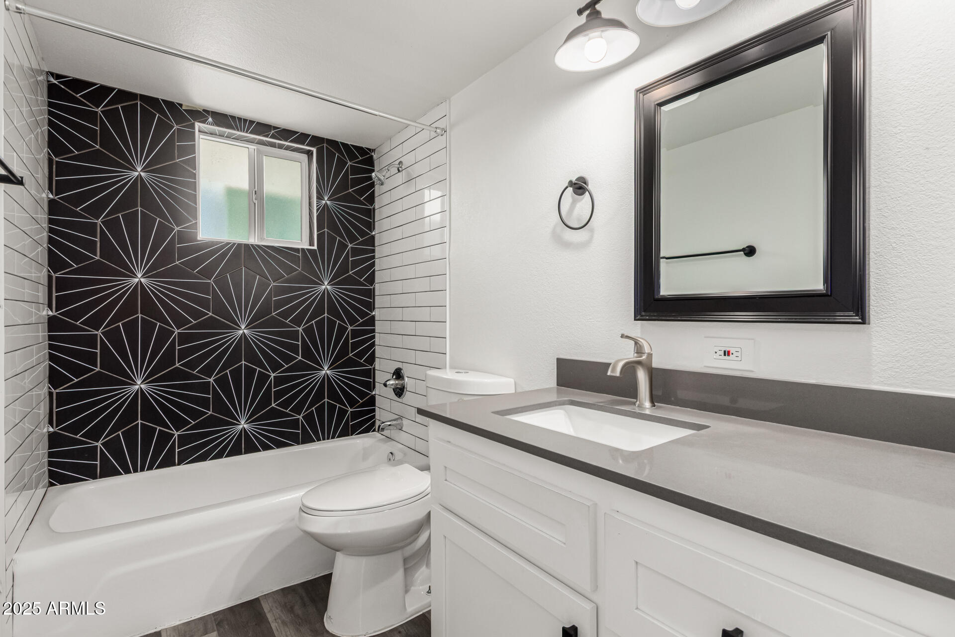 131 North Horne, Unit E Mesa, AZ 85203 - Photo 16 of 26 a bathroom with a toilet a sink and mirror