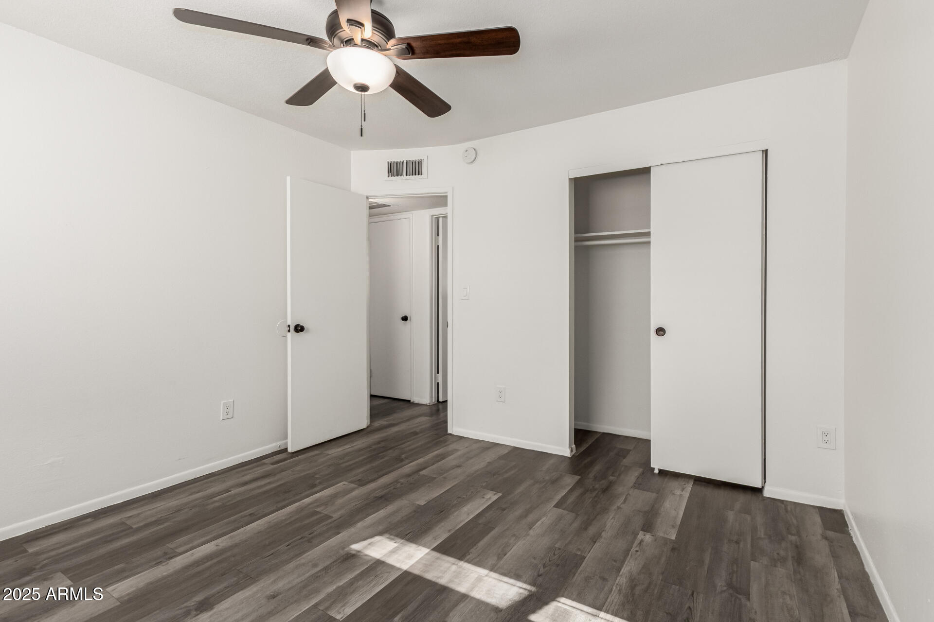 131 North Horne, Unit E Mesa, AZ 85203 - Photo 17 of 26 a view of empty room with wooden floor