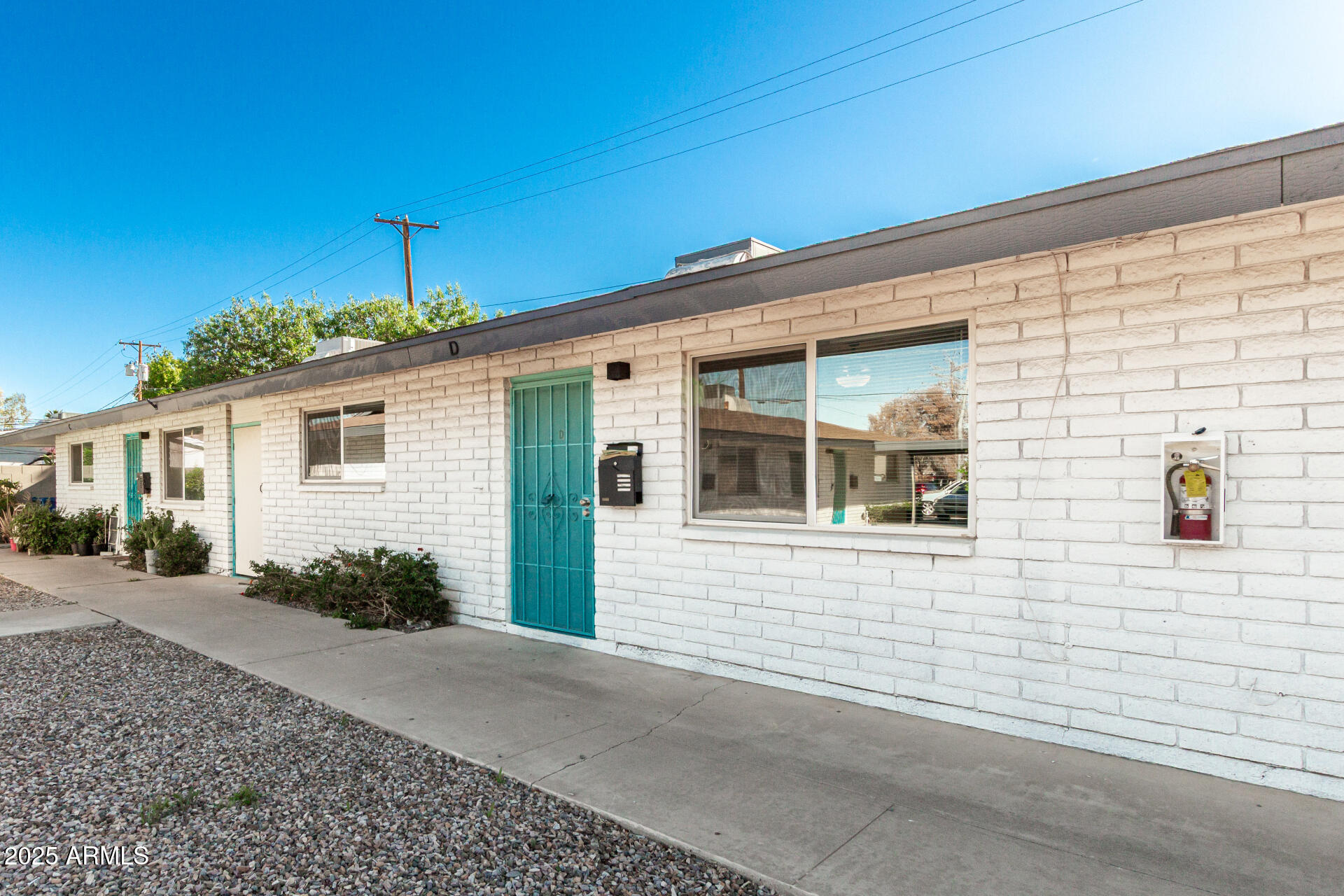 131 North Horne, Unit E Mesa, AZ 85203 - Photo 3 of 26 a front view of a house with a yard