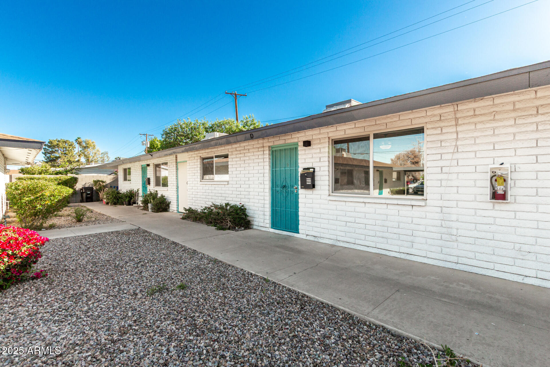 131 North Horne, Unit E Mesa, AZ 85203 - Photo 4 of 26 a front view of a house with a yard