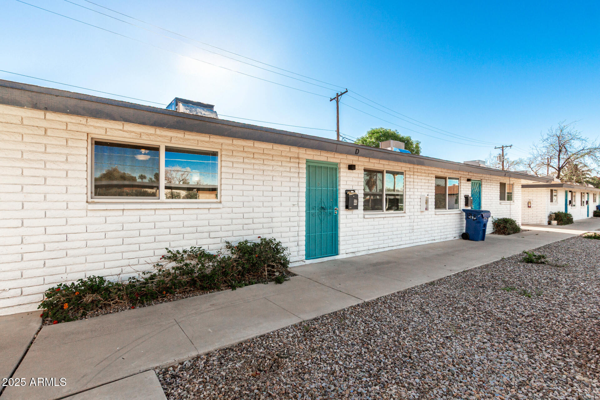 131 North Horne, Unit E Mesa, AZ 85203 - Photo 6 of 26 a front view of a house with a garden