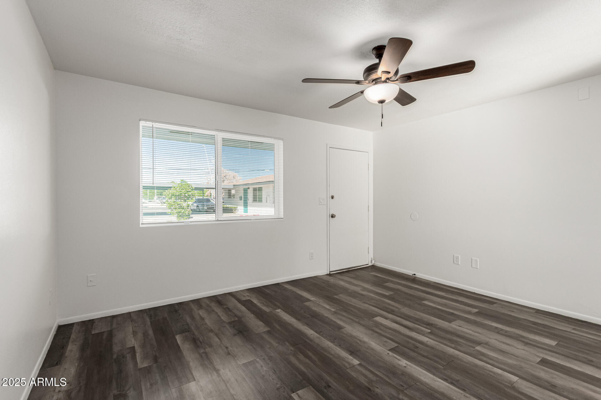 131 North Horne, Unit E Mesa, AZ 85203 - Photo 7 of 26 a view of empty room with wooden floor and fan