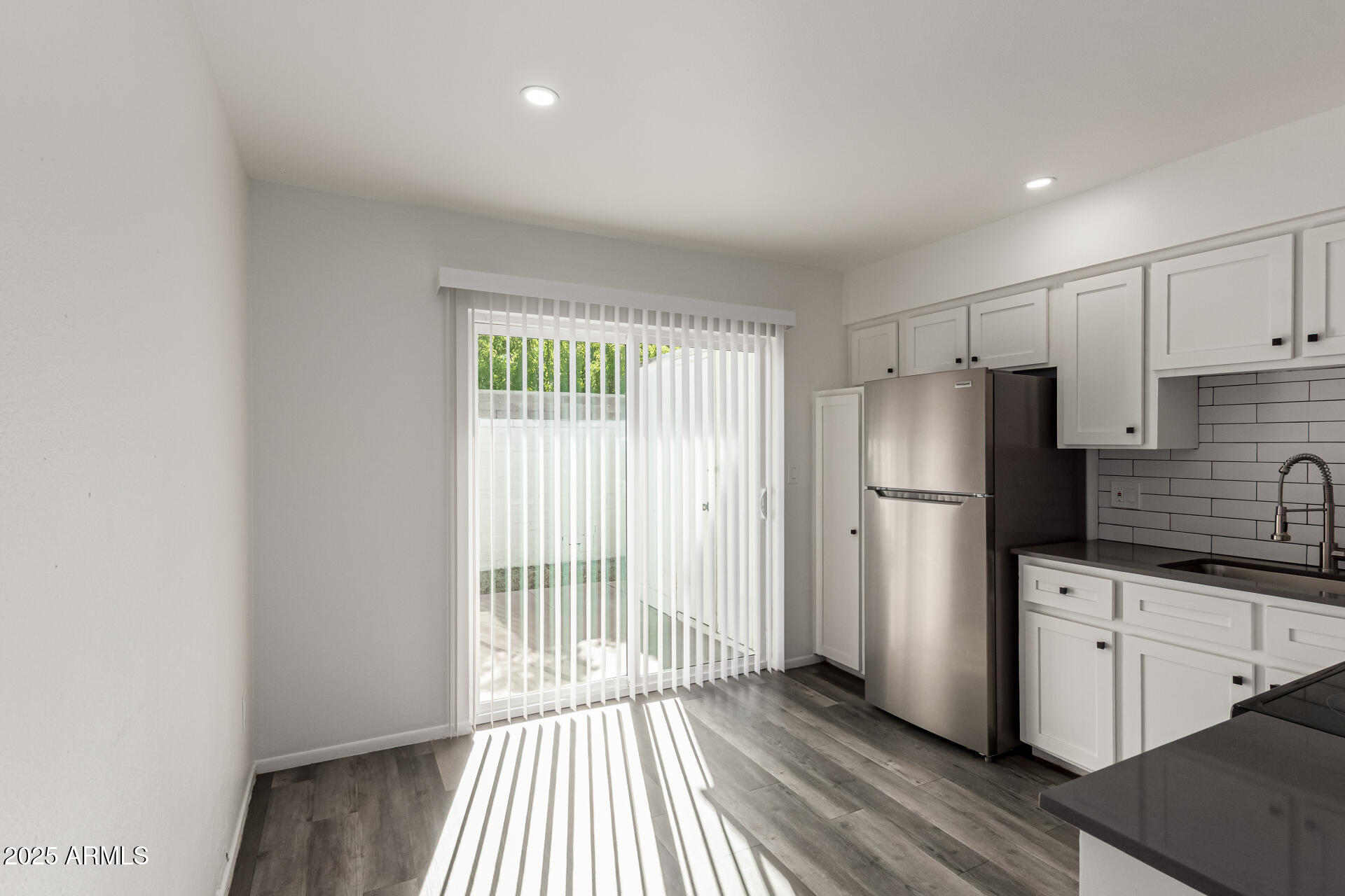 131 North Horne, Unit E Mesa, AZ 85203 - Photo 10 of 26 a kitchen with stainless steel appliances a refrigerator and a sink