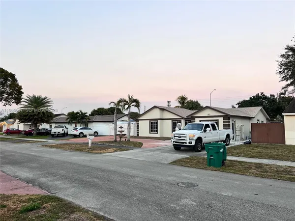 a view of multiple houses with a street