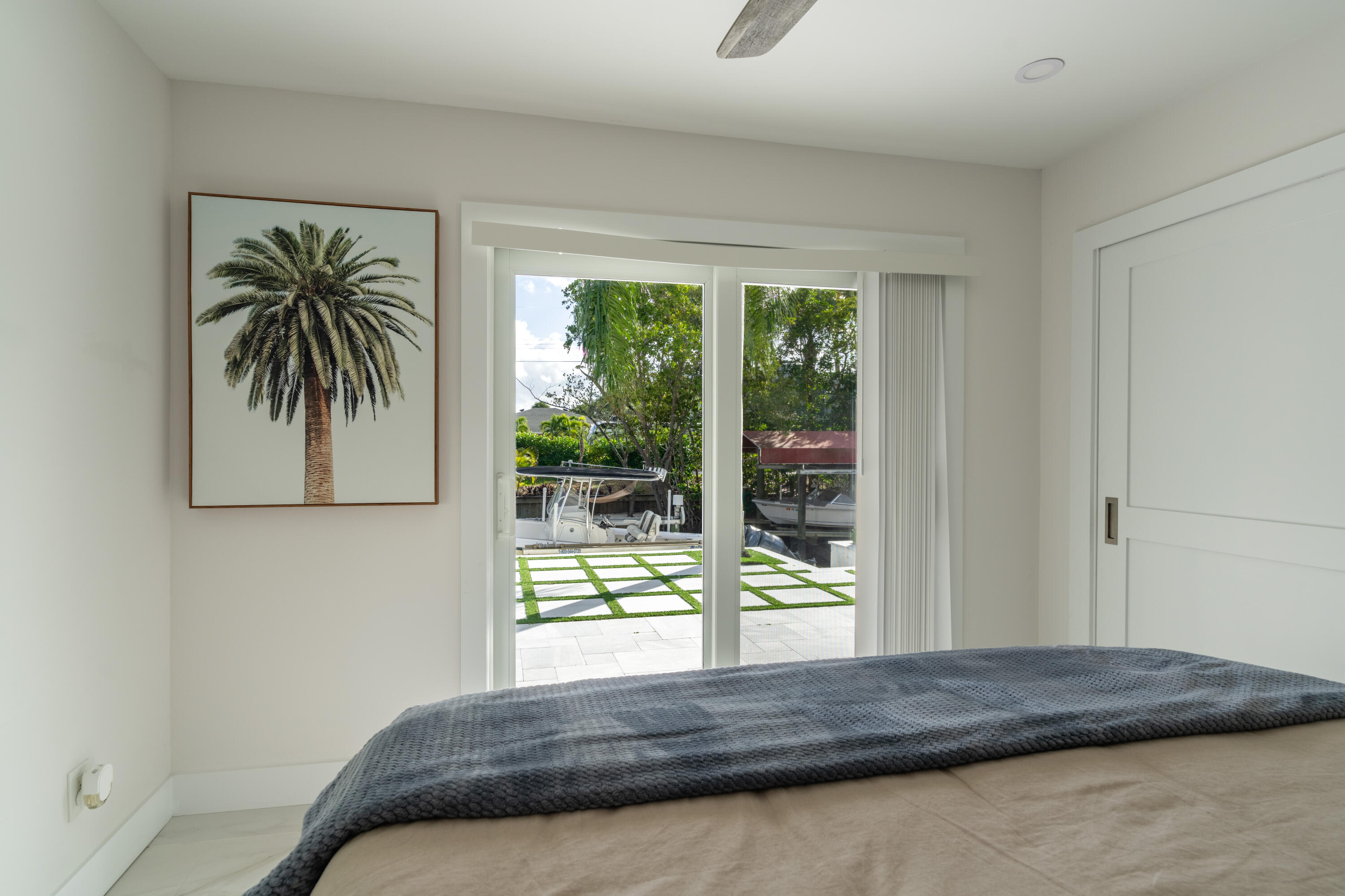 9524 Southeast Cove Point Street Jupiter, FL 33469 - Photo 15 of 35 a bedroom with a bed and a window