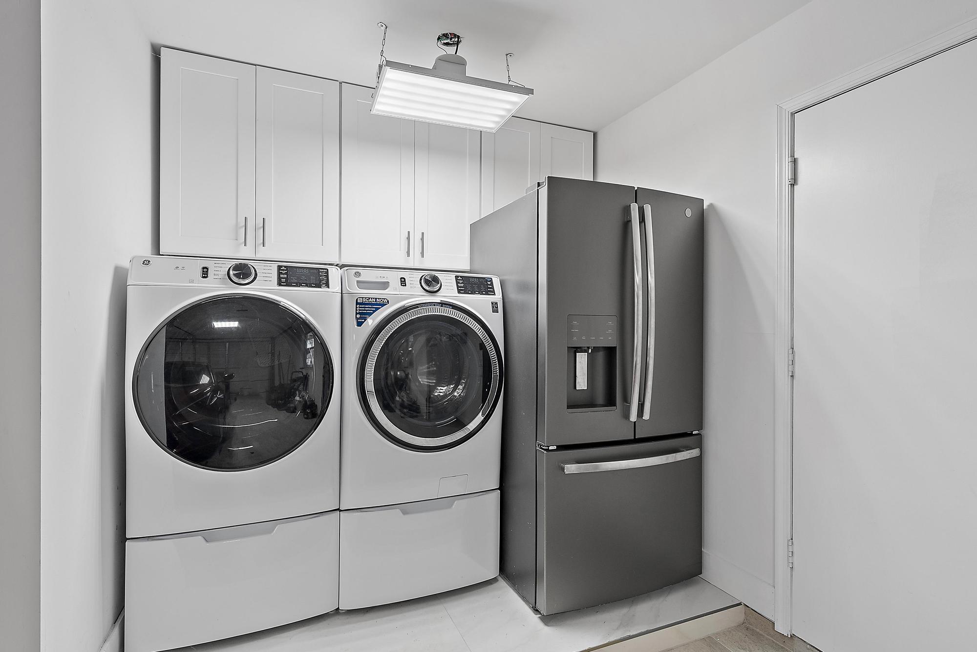 9524 Southeast Cove Point Street Jupiter, FL 33469 - Photo 18 of 35 a utility room with dryer and washer