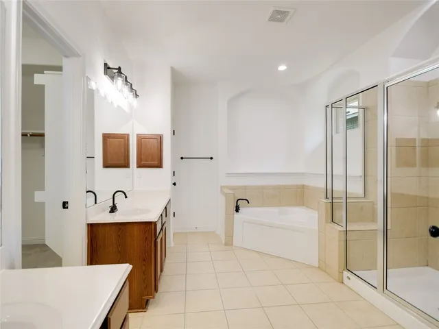 a bathroom with a tub sink and mirror