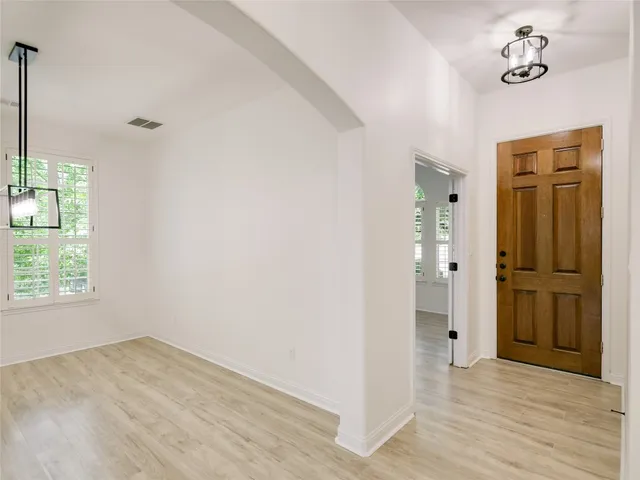 an empty room with windows and closet