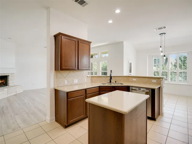 a kitchen with a sink cabinets and appliances