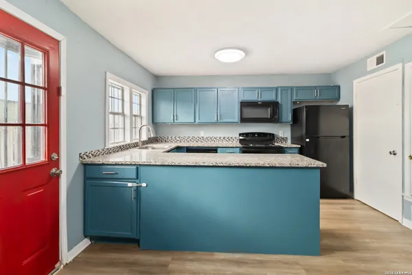 a kitchen with a refrigerator stove and sink