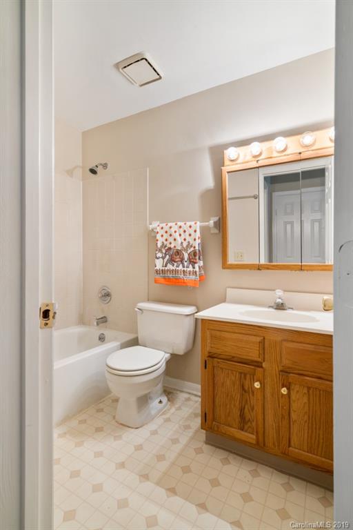 20109 Henderson Road, Unit A Cornelius, NC 28031 - Photo 18 of 25 a bathroom with a toilet sink and mirror