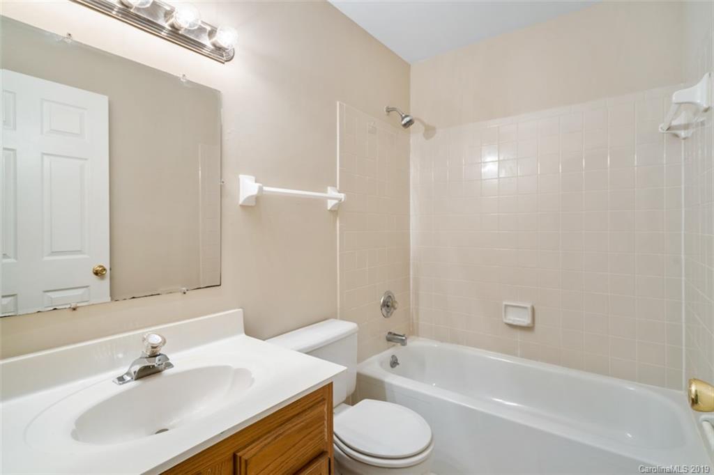 20109 Henderson Road, Unit A Cornelius, NC 28031 - Photo 21 of 25 a bathroom with a sink a toilet and shower
