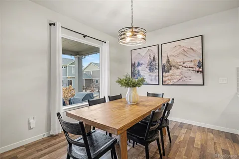 a view of a dining room with furniture wooden floor and chandelier
