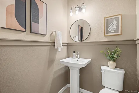 a bathroom with a sink mirror and vanity