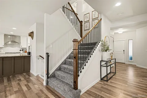 a view of entryway and hall with wooden floor