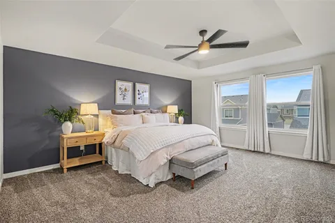a spacious bedroom with a bed table and window