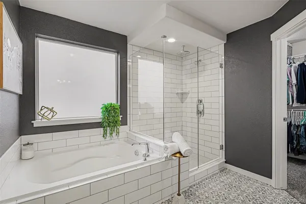 a bathroom with a bathtub and shower