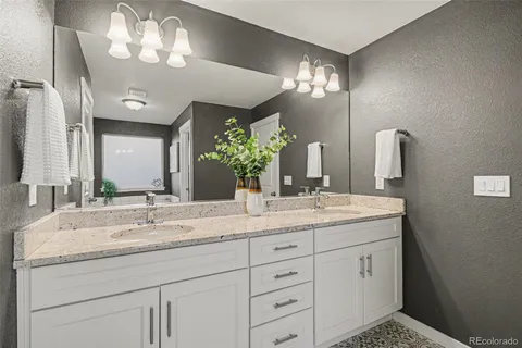 a bathroom with a sink vanity and a mirror