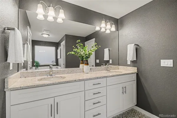 a bathroom with a sink vanity and a mirror