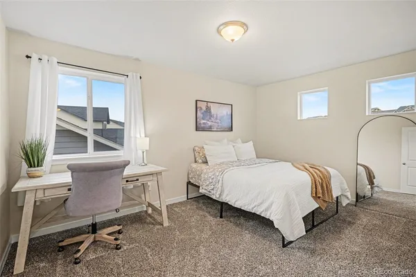 a bed room with a bed and a chair