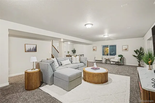 a living room with furniture and a potted plant