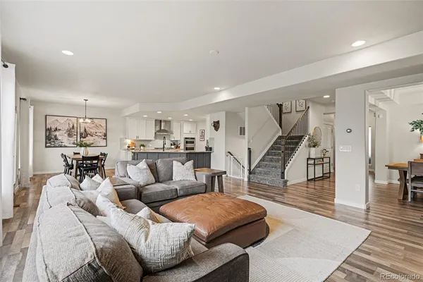 a living room with furniture and wooden floor