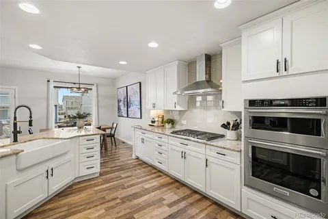a kitchen with stainless steel appliances granite countertop a stove sink and cabinets