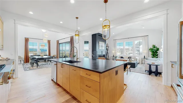 a kitchen with sink cabinets and living room view