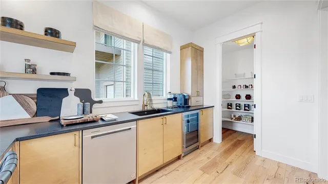 a kitchen with stainless steel appliances a sink stove and cabinets