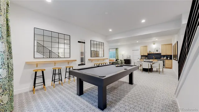 a room with furniture pool table and windows